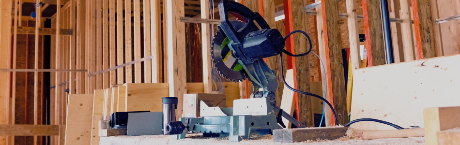 machinery to cut the timber frame in the foreground with the house timber framing in the background