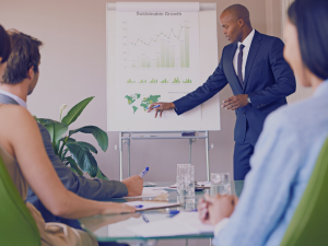 person pointing at whiteboard which says sustainable growth