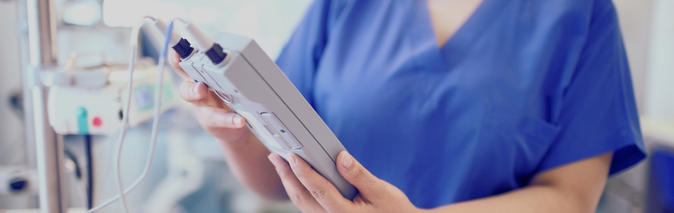 nurse holding a medical device screen