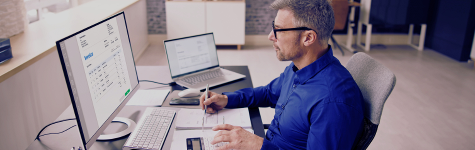 corporate worker in front of multiple screens