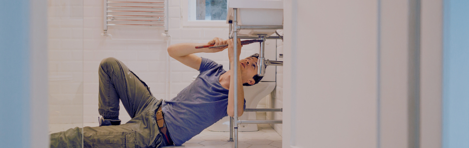 Plumber working on a bathroom sink
