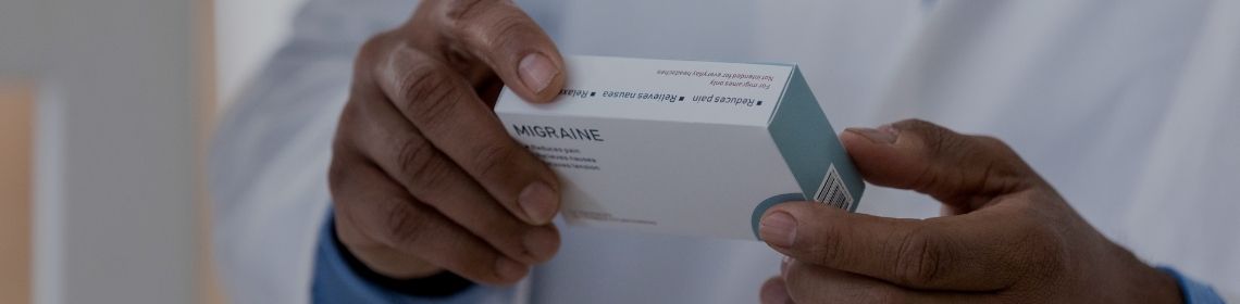 Pharmacist holding a medication box 