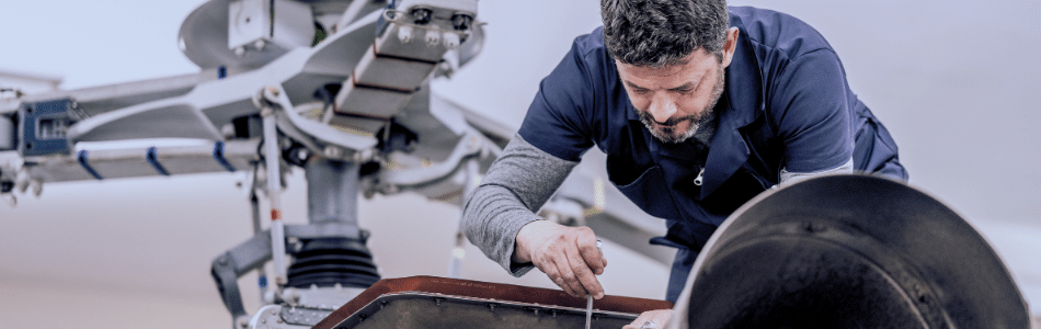 man fixing parts of an aeroplane