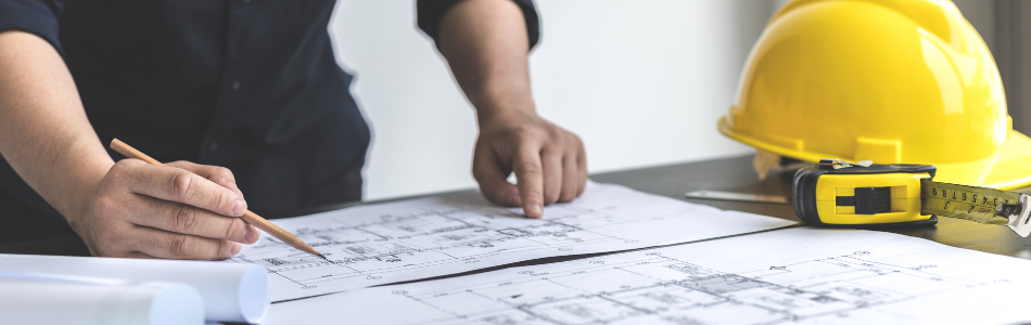 engineer looking over blueprint documents
