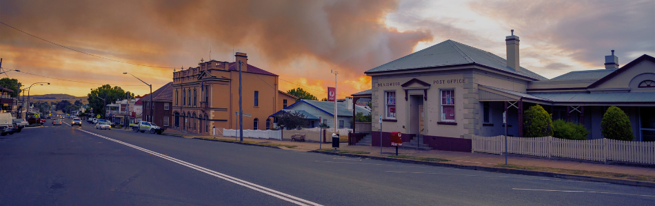 Bushfire in the background of an empty suburban street