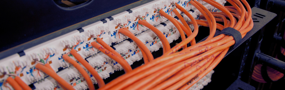 Stack of orange cables with technical labelling