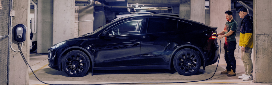 black EV car being charged in an underground carpark