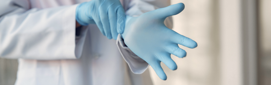 Person putting in blue rubber gloves