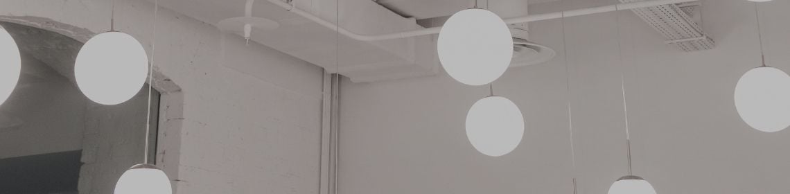 Globe style lights hanging down from ceiling 