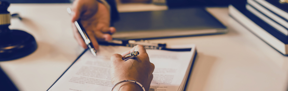 hand signing a business document