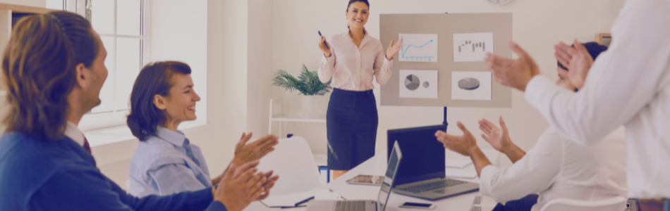 Team meeting with office workers smiling and clapping