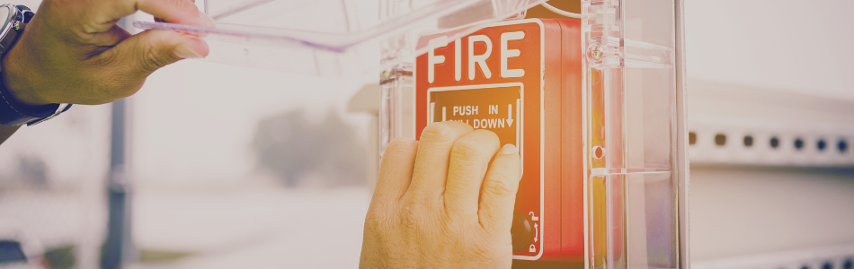 person putting hand on the fire safety sprinkler switch