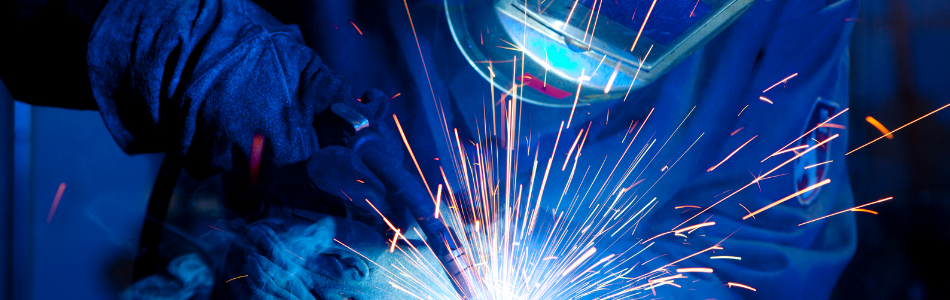 person welding steel together